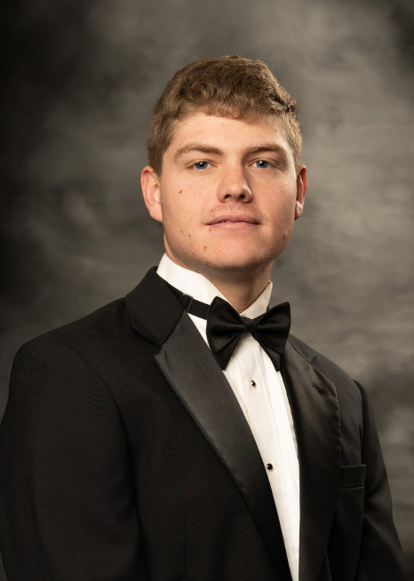 young man in a black and white suit for senior pictures
