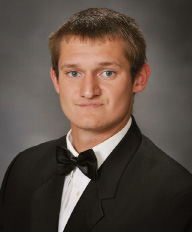 young man in a black and white suit for senior pictures