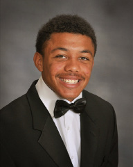 young man in a black and white suit for senior pictures