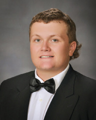 young man in a black and white suit for senior pictures