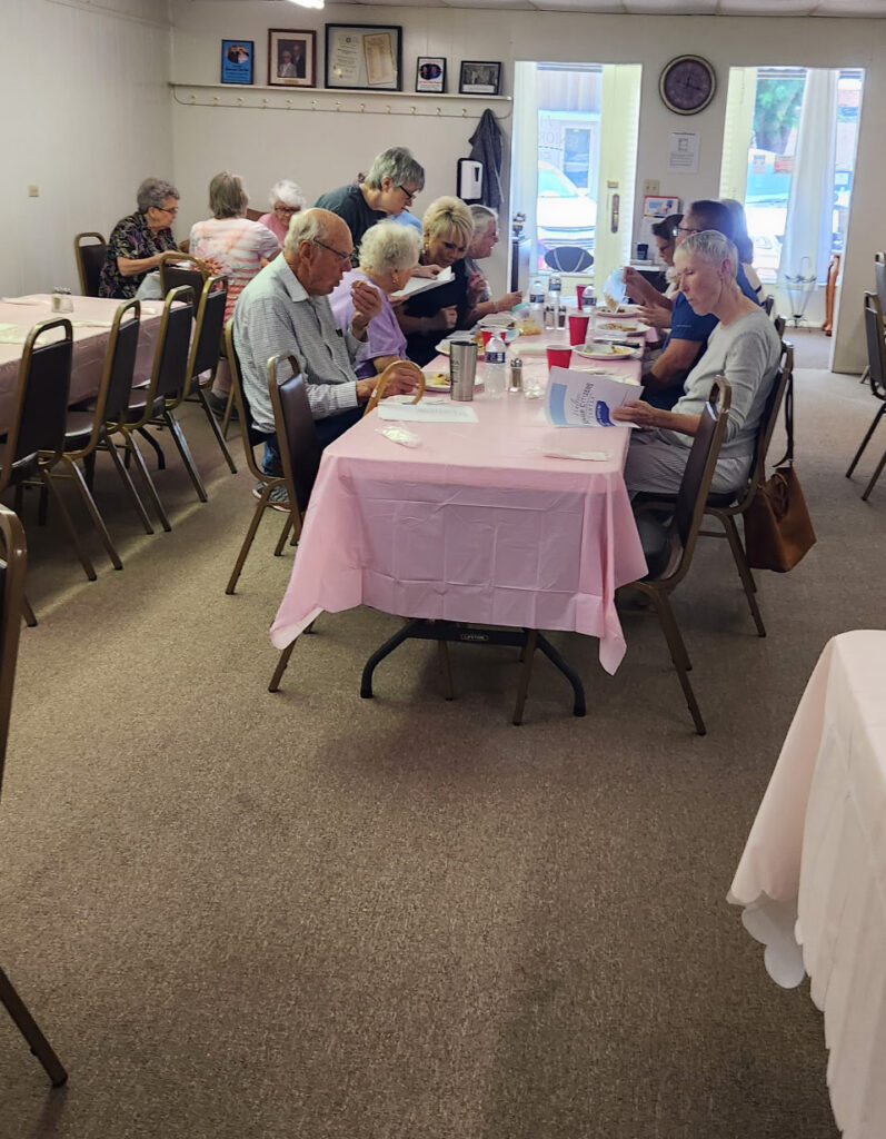 Group of Walters Senior Citizens Center members and board members gathered together indoors for their annual meeting.